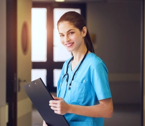 A female health staff smiling