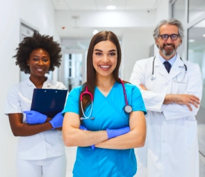 Three health workers smiling together