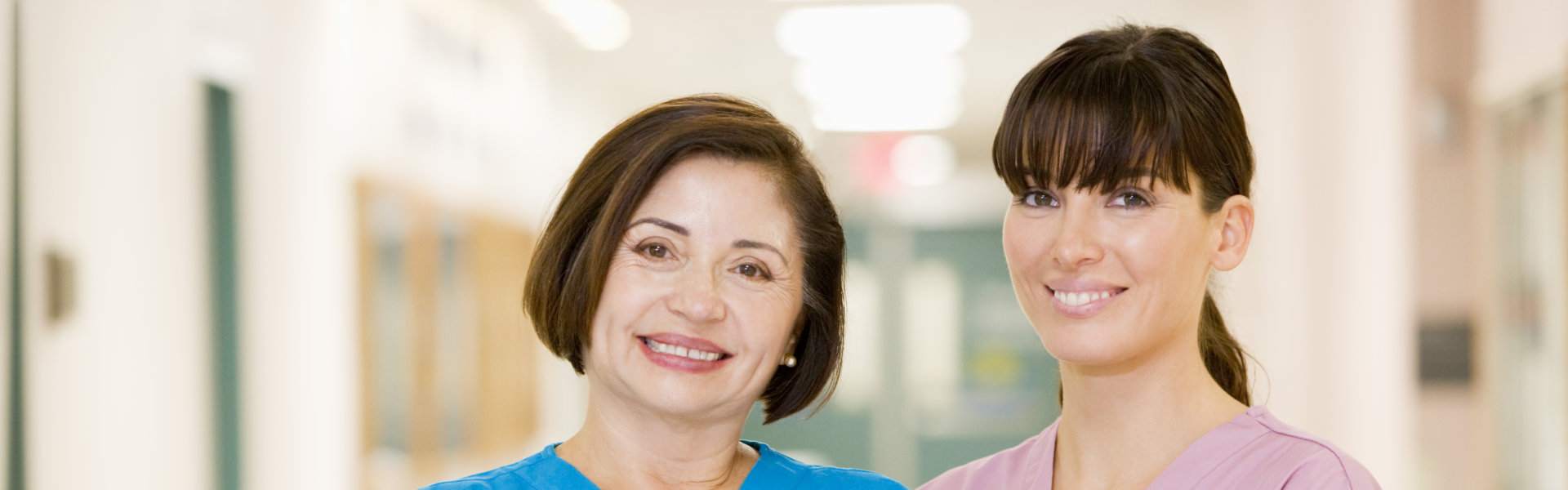 Two healthcare staff smiling